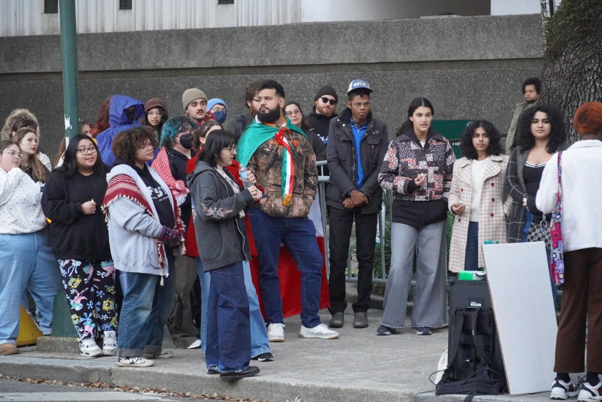 Student protestors standing on the Freret St sidewalk by Stern Hall. They would later walk toward the Loyola Broadway Campus. 