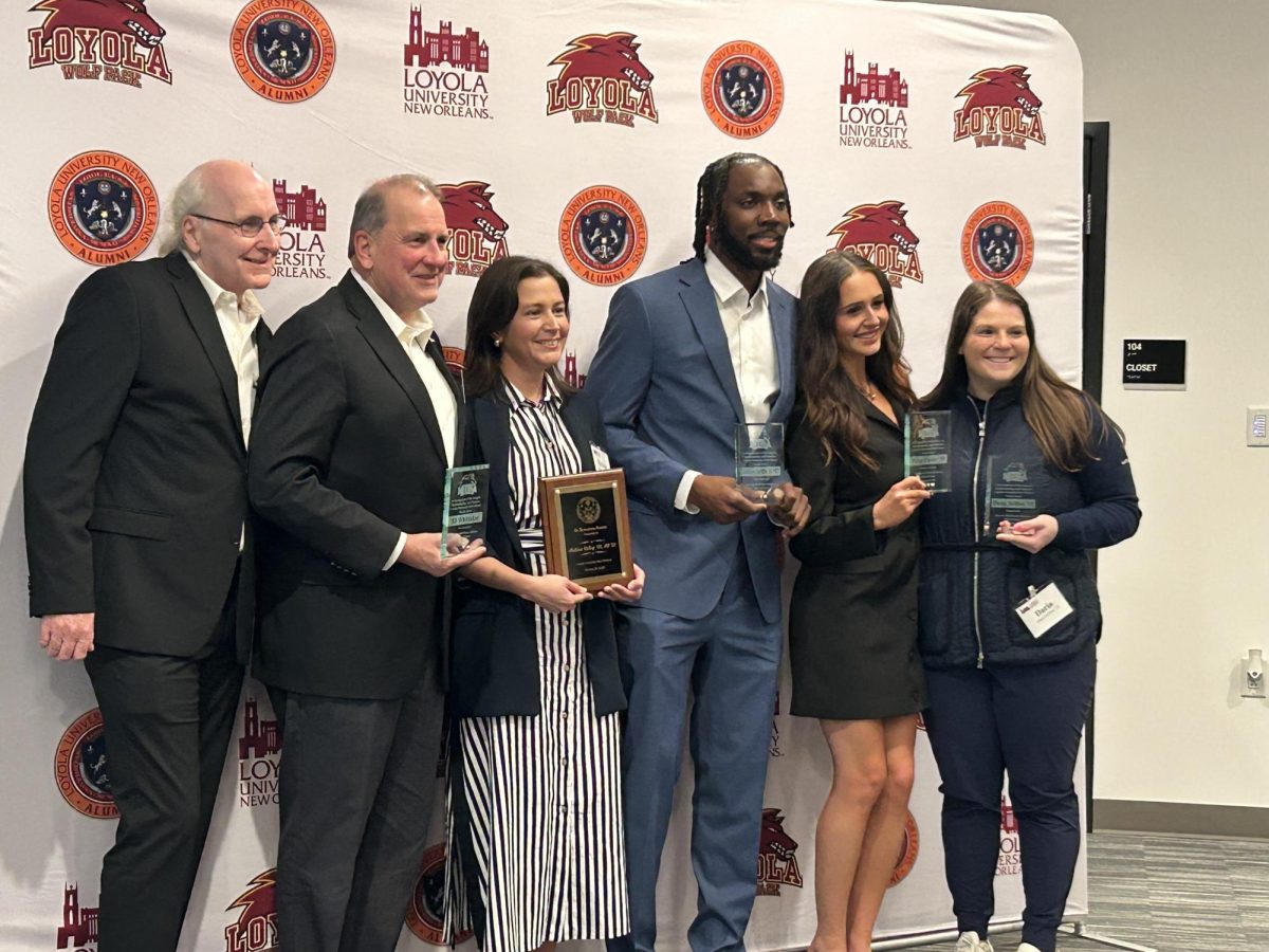 Tommy Wittaker two sons Grant and Scott, Melissa Ridley, Johnny Griffin Jr., Paige Carter, and Daria Delfino posing with hall of fame trophies. The have been recently inducted into universities hall of fame .  Amari Winchester/The Maroon