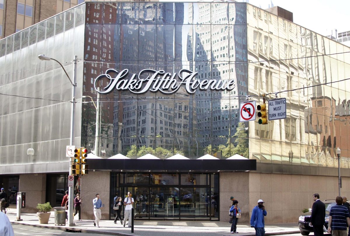 People walk along Smithfield Street in downtown Pittsburgh past the Saks Fifth Avenue department store on Thursday, Oct. 6, 2011. Saks Fifth Avenue announced on Wednesday Oct. 5, 2011 that it will be closing this store after they couldn't raise the funding needed for improvements to the store. (AP Photo/Keith Srakocic)