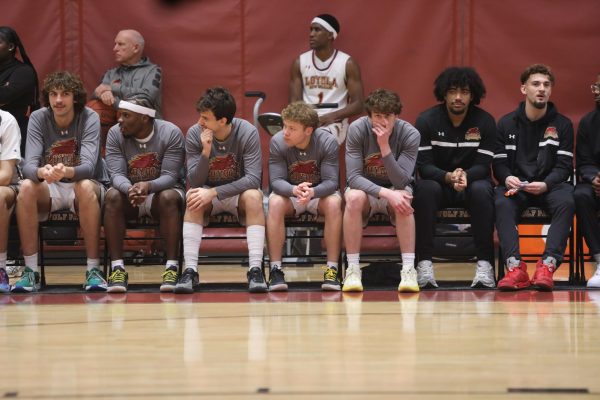 Mens team sitting on the side of the court. They have won their last two home games and Competing in the SSAC Championship.