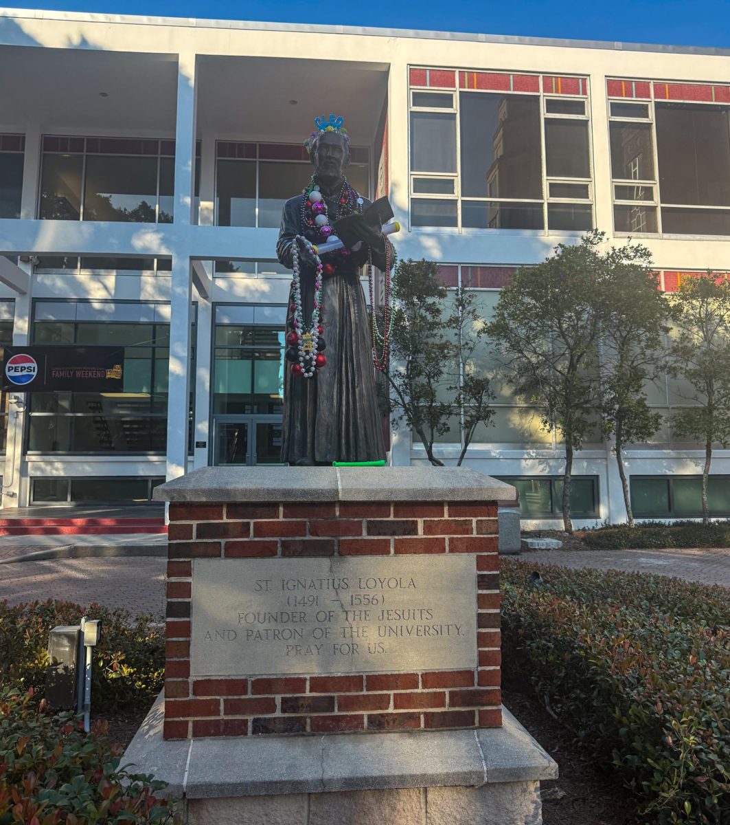 Mardi Gras beads left on St. Ignatius statue outside Danna Student Center.