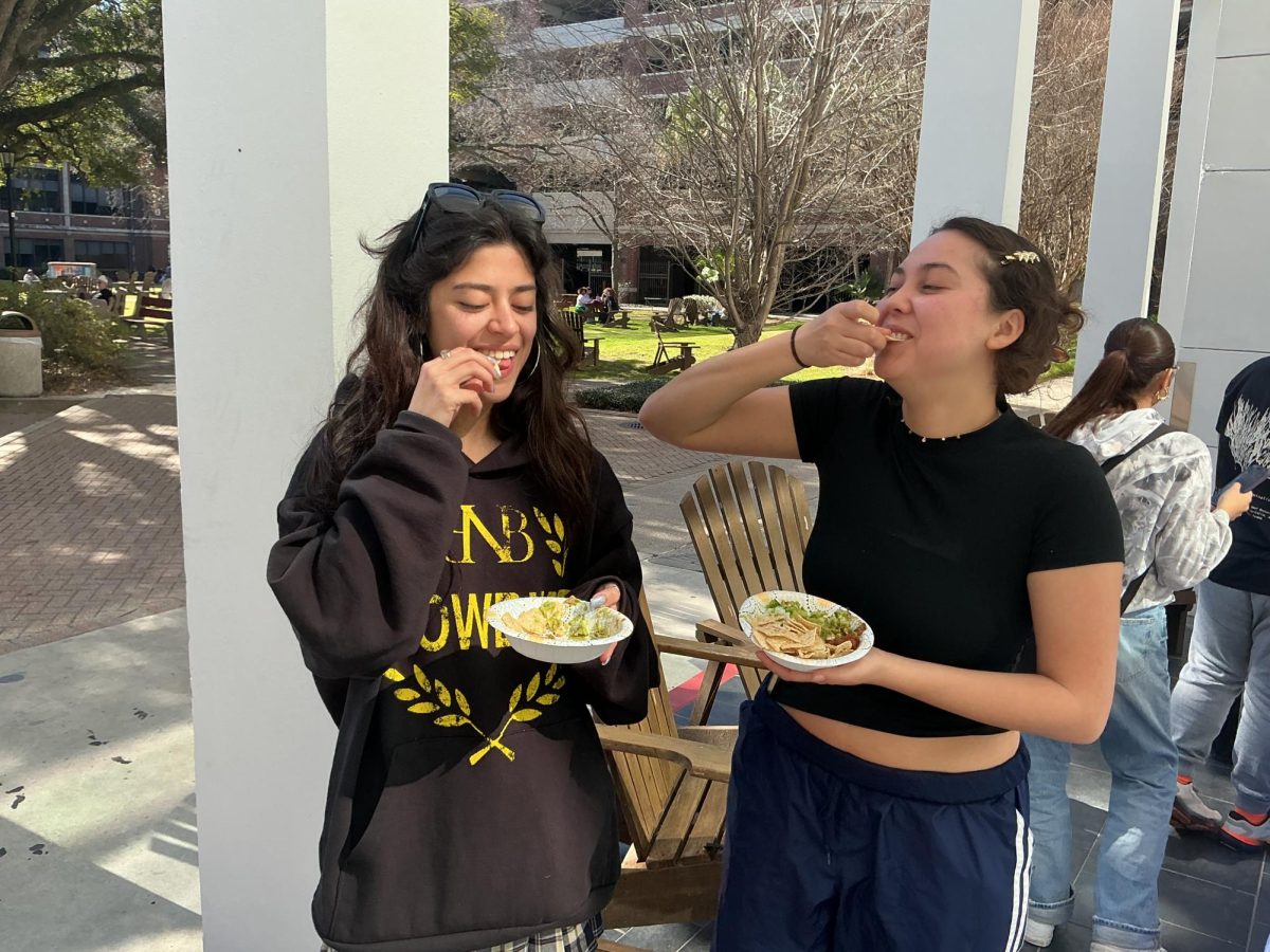 Isabella Jayne and Emily Keller enjoying guacamole, salsa, jalapeños, onion, and cilantro. The Study Abroad Fair was held in the peace quad to promote studying abroad to students.