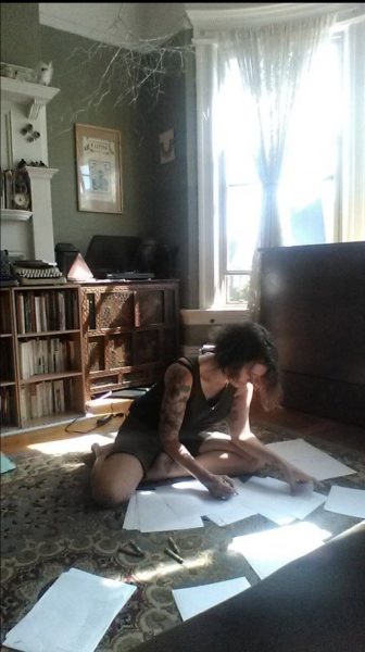 Thibodeaux looking at her manuscript, courtesy of Thibodeaux
