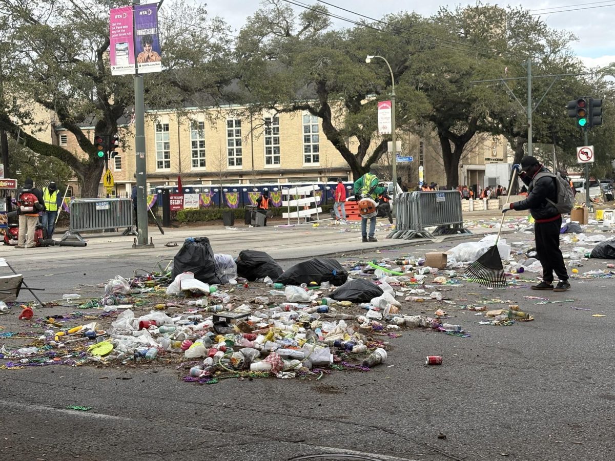 Cleaning crew raking trash after parades on Napoleon and St. Charles, Tuesday, Feb. 17.  