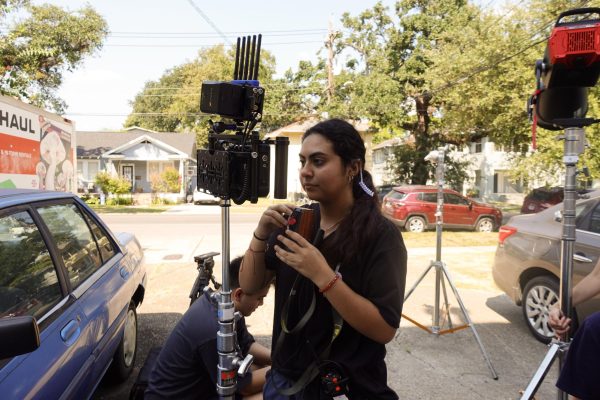 Katherine Mejia, first assistant camera pulling focus on set for "Princess of Claiborne" at a house in the Freret neighborhood on Sept. 13, 2025. Mejia's tasks included swapping lenses, pulling focus, and generally serving as an assistant to the director of photography. Courtesy of Kassidy Pattain.
