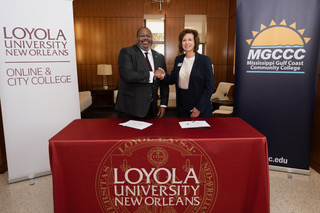Presidents Xavier Cole of Loyola University and Mary Graham of Mississippi Gulf Coast Community College shake hands to formalize the schools' partnership on Loyola's campus on April 27, 2026. Courtesy of Kyle Encar for the Maroon